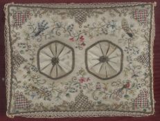 An 18th century cream silk embroidered kneeler, framed and glazed, embroidered with polychrome silks