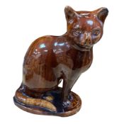 A Victorian Canney Hill pottery treacle-glazed model of a seated cat, 29cm high