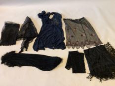 A 1920’s black net and pink beaded skirt, a navy beaded dress, a knitted shawl and black damask