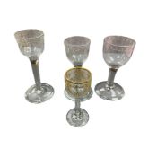 Three Georgian engraved wine glasses and a similar gilded wine glass, largest 14cm high