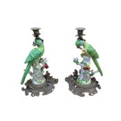 A pair of Meissen style gilt metal mounted ceramic candlesticks modelled as parrots perched on