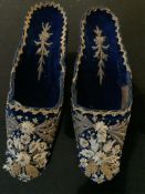 A pair of early 19th century Turkish style lady's navy velvet embroidered slippers, with heavily