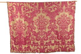 A 19th century large Baroque style silk and cotton damask, woven in gold and burgundy on a narrow