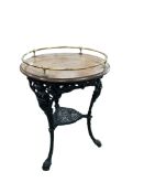 A Victorian cast iron circular table with brass galleried mahogany top, diameter 61cm, overall