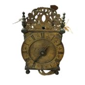 ° ° A late 17th / early 18th century lantern clock, with pendulum and weight, striking on a bell