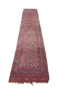 A red ground Afghan runner, 360 x 70cm
