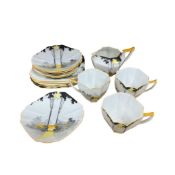 An Art Deco Shelley Tall Trees and Sunrise part tea set comprising a milk jug, three cups, six