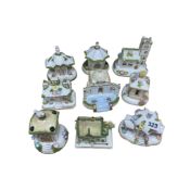 A group of nine Coalport porcelain cottage pastille burners, largest 14cm high.