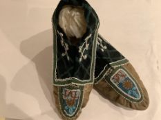 A pair of late 19th century North American Native bead worked moccasin slippers, with wide velvet