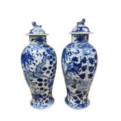 A pair of Chinese blue and white baluster “dragon” vases and covers, height 31cm