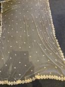 A late 19th century Brussels bobbin lace on net wedding veil, 160cm wide x 246cm long.