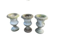 A set of three reconstituted stone campana garden urns, diameter 48cm, height 70cm