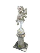 A reconstituted stone cherub garden fountain on fluted pedestal (damaged leg) and a pottery bust