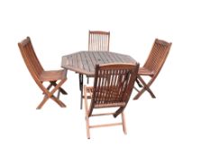 An octagonal weathered teak folding garden table, width 110cm, height 72cm together with four