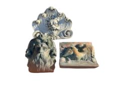Two cast stone mask and lion mask fountain heads, larger height 46cm together with a Leda and The