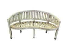 A weathered teak garden 'banana' bench, width 150cm, depth 60cm, height 87cm