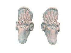 A pair of cast stone ram's head garden wall pockets, height 44cm