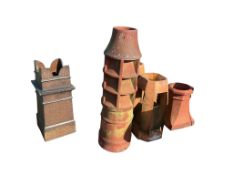 Seven assorted Victorian and later earthenware chimney pots, largest height 106cm