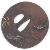 A Japanese cast iron and mixed metal tsuba, 19th century, decorated with a hawk chasing a goose,