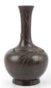 A Japanese bronze bottle vase, signed, Meiji period, cast in relief with fish amid pondweed, the