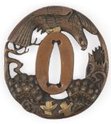 A Japanese bronze and mixed metal ‘eagle’ tsuba, 19th century, cast in relief and pierced with an