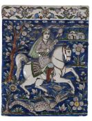 A Persian fritware polychrome moulded tile, Qajar dynasty, decorated with a knight on horseback