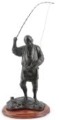 A Japanese bronze figure of a fisherman, 19th century, the fisherman holding a rod in his right hand