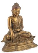 A Burmese bronze seated figure of Buddha Shakyamuni, 19th century, tinted mirrored glass to his head