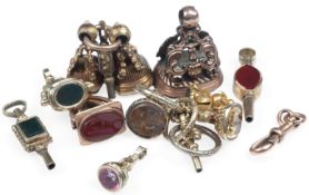 A collection of gold mounted hardstone fobs and watch keys, mid-late 19th century, comprising: a 9ct