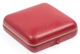 A Cartier London brooch case, mid 20th century, in red leather, lined with black velvet, measuring