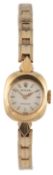 A lady's 18k gold Rolex Precision manual wind wrist watch, on an associated 14k gold bracelet,