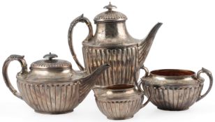 A late Victorian fluted silver oval four piece tea and coffee service, by William & John Barnard,