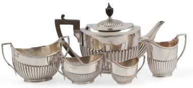 An Edwardian demi-fluted silver oval three piece tea set, William Hutton & Sons, London, 1906(2) and