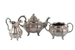 A Victorian silver melon shaped three piece tea set, by William Hunter, with engraved foliate