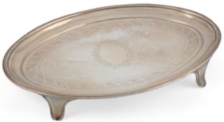 A George III silver oval teapot stand by John Eames, with engraved decoration, reeded border, on