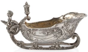 An Edwardian silver sauceboat, modelled as a sleigh, by William Comyns, with caryatid handle and