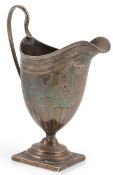 A George III silver helmet shaped pedestal cream jug, by Soloman Hougham, with reeded loop handle