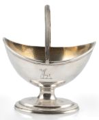 A George III silver boat shaped pedestal sugar basket, by Peter & Ann Bateman, with engraved