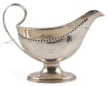 A George III silver pedestal sauce boat, by Hester Bateman, with pinched beaded border and