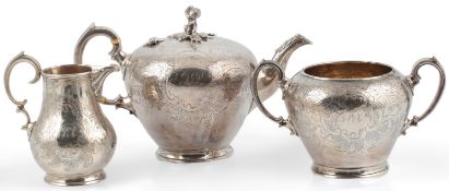 A Victorian engraved silver three piece tea set, by Walter Morrisse, of pyriform and inverted
