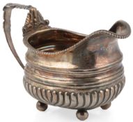 A late George III demi-fluted silver cream jug, by J.E. Terry & Co, with shell and acanthus leaf