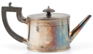 A George III silver oval bachelor's teapot by James Stamp, with engraved geometric bands and