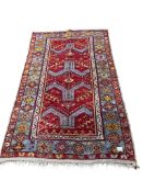 A Turkish red ground rug, 180 x 107cm