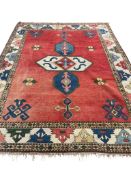 A Caucasian style red ground carpet, 320 x 230cm