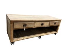 An early 20th century pine and beech three drawer baker's work table on six original cast iron