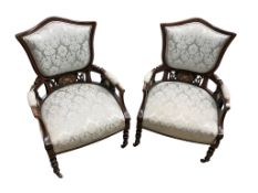 A pair of Edwardian mahogany and marquetry inlaid upholstered armchairs, width 62cm, depth 52cm,