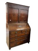 A George III oak bureau cabinet, width 124cm, depth 55cm, height 208cm