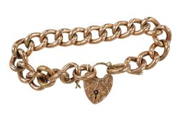 An Edwardian 9ct engraved curb link bracelet, with heart shaped padlock clasp, approx. 18cm, 21