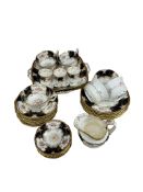 A Coalport blue and gilt bordered part tea and coffee service, to include cups and saucers and a