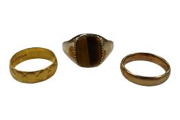 A late 1960's engraved 22ct gold band, size J, 3.2 grams, a 9ct gold wedding band and a 9ct gold and